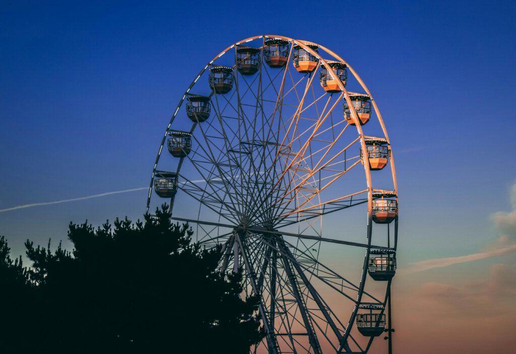 A stunning view of a Ferris wheel silhouetted against a twilight sky in Bournemouth, England.
